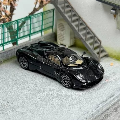1/64 scale black diecast sports car model with openable hood detail
