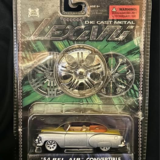 Collectible diecast metal convertible car in blister pack, silver with detailed wheels