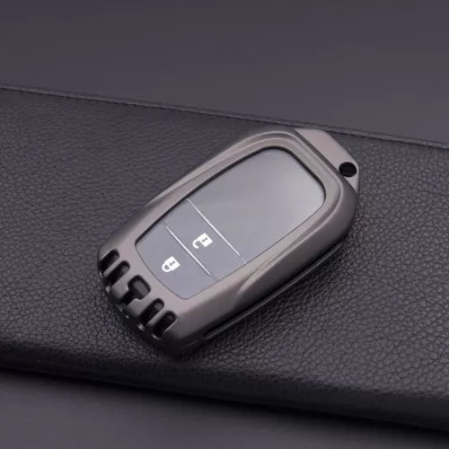 Diecast model car key fob part in metallic gray with button details