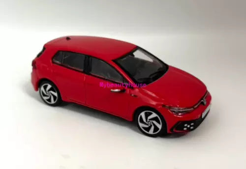 Red metal diecast hatchback model car, angled side view