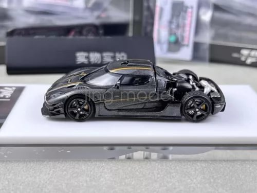 1:64 scale black metal diecast racing car model with gold front accents