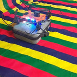Black quadcopter drone with propellers and colorful status lights