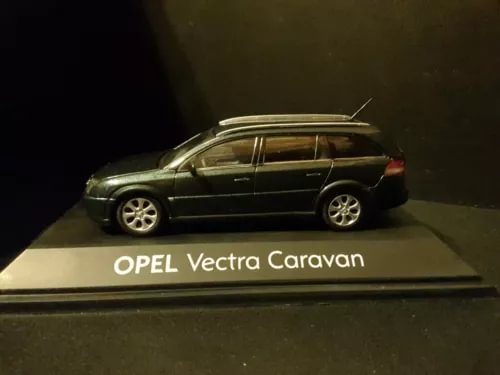 Dark diecast station wagon model car with Opel Vectra Caravan markings on base