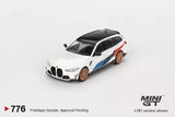 1:64 scale diecast BMW M3 model, white with blue stripe and orange wheels