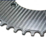 Carbon fiber machining plate with gear-tooth cutouts, dark gray weave