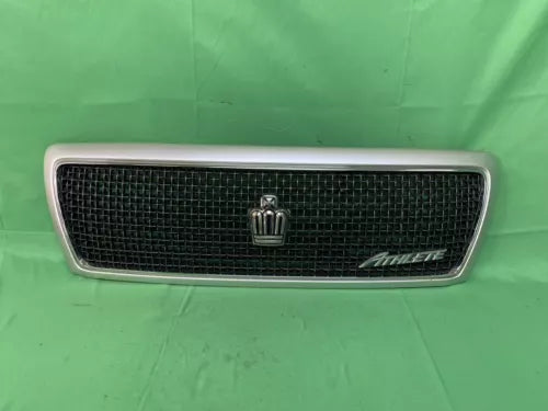 White diecast car front grille with chrome emblem and badge