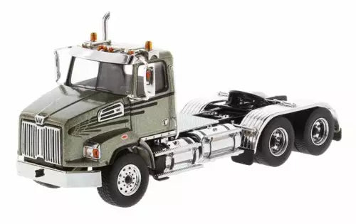 Green diecast tandem day cab tractor with chrome grille, black wheels, and open chassis