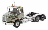Green diecast tandem day cab tractor with chrome grille, black wheels, and open chassis