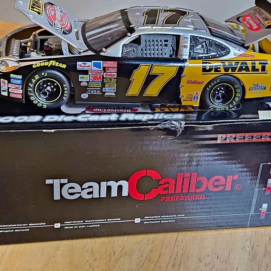 Diecast NASCAR race car model with #17 Team Caliber livery, blue and yellow wheels.