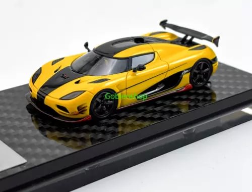 Yellow and black sports model diecast car on black display base, front 3/4 view