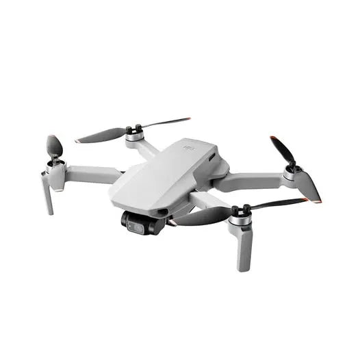 White quadcopter drone with four propellers and front camera module