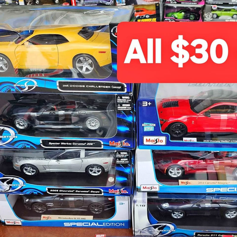 Yellow 1:18 scale diecast sports car in retail blister box