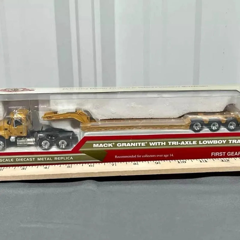 Mack Granite diecast tri-axle lowboy truck in clear blister package