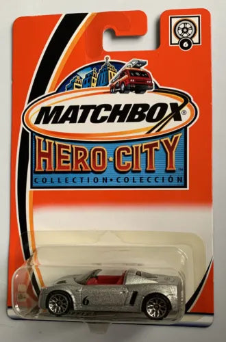 Silver diecast car model in blister pack, Matchbox Hero City design, front view.