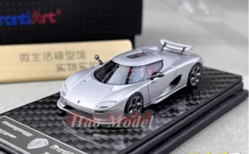 Silver alloy diecast sports car model on black display base, detailed body and wheels