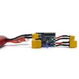Electronic fuse module with blue circuit board, yellow connectors, and red/black wires