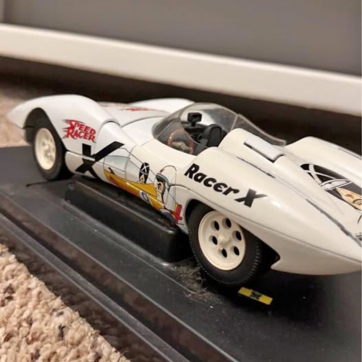 White diecast race car with black accents, open cockpit, rear wing and racer decals