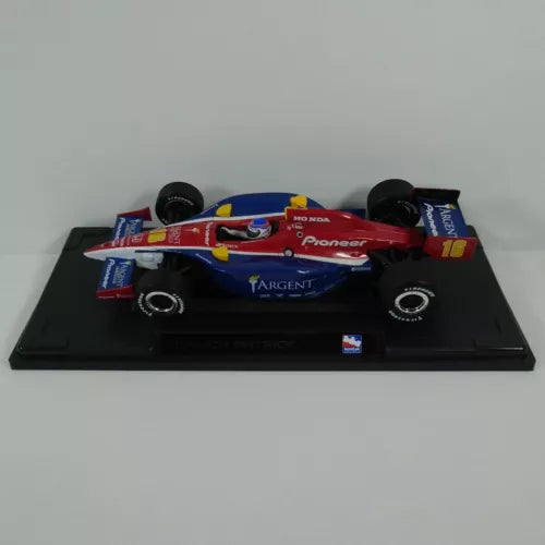 Diecast IndyCar model with red and blue race car, number 16, on black base