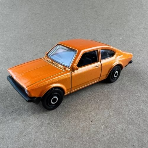 Orange 1:64 diecast coupe model car with black wheels and hood