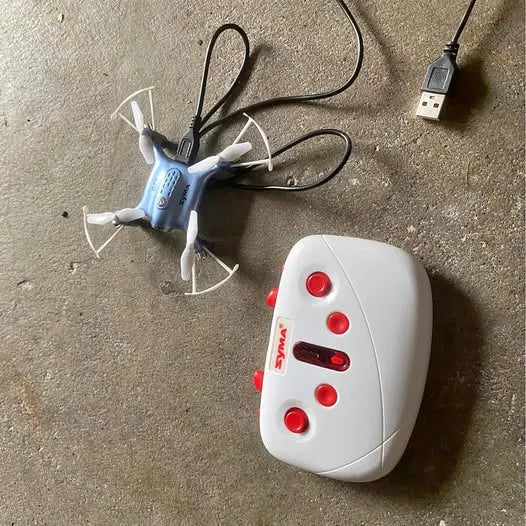Light blue mini drone with white remote controller and USB cable