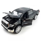 Dark gray Toyota pickup truck diecast model car with open hood and front grille