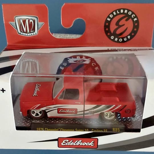 Red and white 1:64 diecast car model in clear display box, Edelbrock graphics