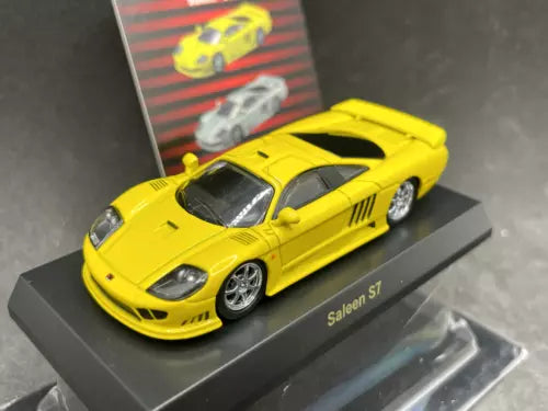 Yellow Saleen S7 diecast model car with black hood vents on display base