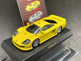 Yellow Saleen S7 diecast model car with black hood vents on display base