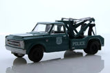 Dark green police wrecker tow truck diecast model with lifting boom