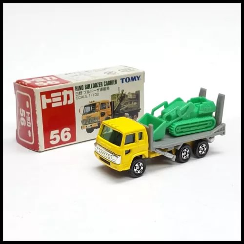 Diecast bulldozer carrier truck with yellow cab and green bulldozer, boxed scale model