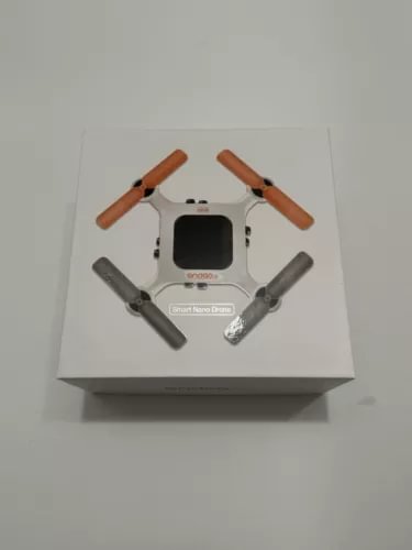 Onagofly Smart Nano Drone V1.2 with white body, four gray arms, orange propellers