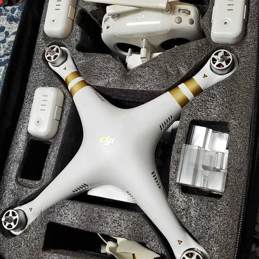 DJI Phantom 3 Advanced drone, white with gold accents and propellers