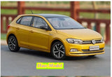 Yellow Volkswagen Polo diecast model car, front three-quarter view