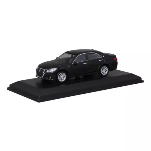 Black diecast sedan model car on black display base