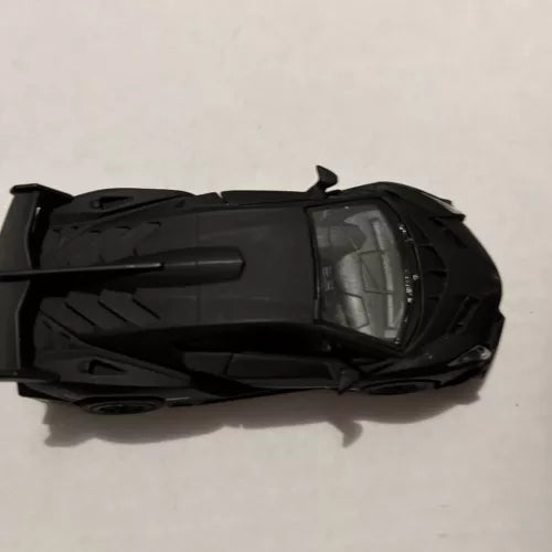 Matte black diecast toy sports car model, top view, 1:36 scale