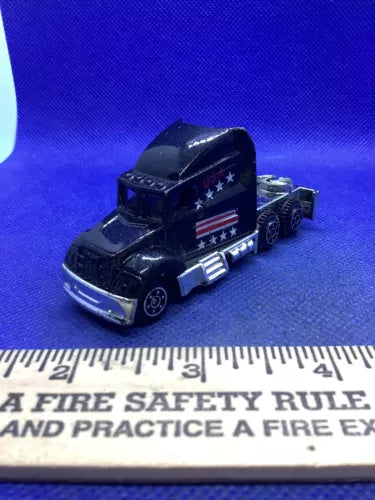 Patriotic diecast semi cab tractor model with dark blue stars and stripes decals, front view