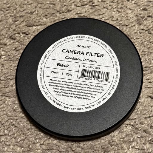 Black 77mm cinebloom diffusion camera filter, circular lens cover
