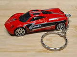 Red diecast model car keychain with black hood and chrome keyring loop