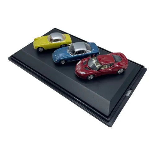 Diecast car set with three Lotus models in yellow, blue, and red on black base