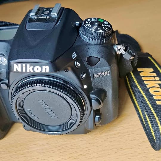 Nikon D7200 digital camera body with front lens cap and Nikon logo
