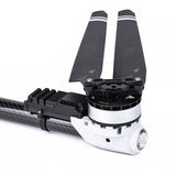 RC quadcopter motor with two dark prop blades, black and white housing