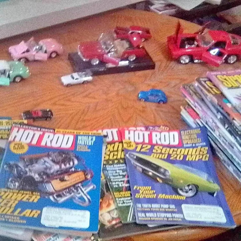 Hot rod magazines with blue covers and large Hot Rod lettering, stacked on table