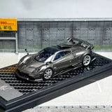 Grey 1/64 scale Pagani Imola diecast car model with openable detail, on display base