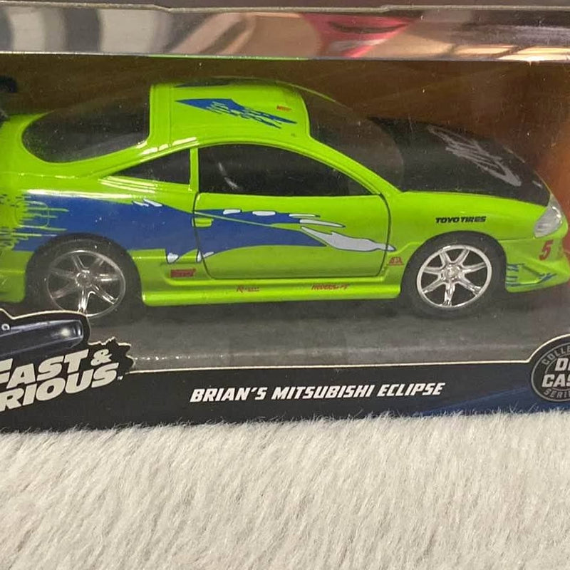 Hot Wheels diecast car, lime green Mitsubishi Eclipse with hood graphics and chrome wheels in box