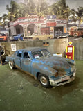 Light blue classic diecast car model with front three-quarter view and chrome bumper