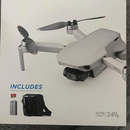 DJI Mini 2 drone with propellers and mounted camera, light gray body