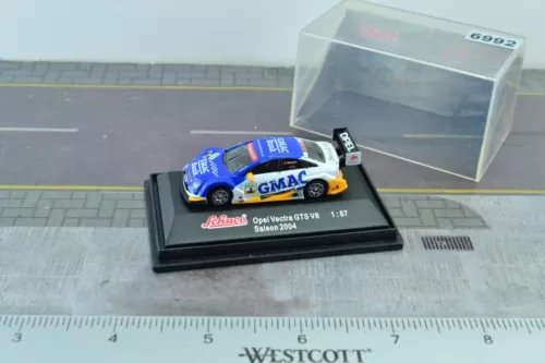 Blue race car diecast model with white accents, in display case base
