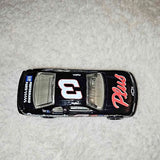 Die-cast toy car, black with colorful decals and detailed grille, compact size.
