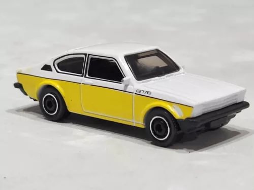 Diecast toy car with white and yellow body, black wheels, front three-quarter view