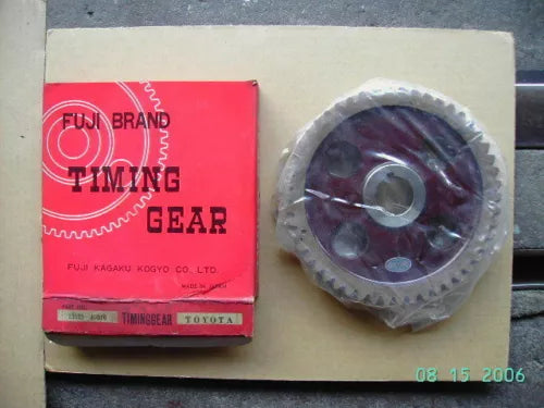 Timing gear part with FUJI brand packaging, round metal gear, dark finish
